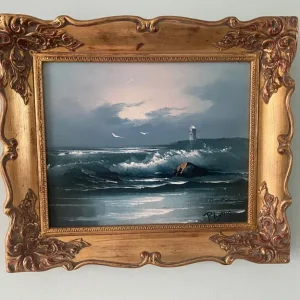 Seascape with lighthouse painting in ornate golden frame