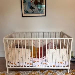 White baby cot with organic mattress