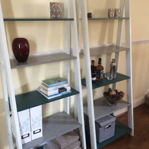One remaining ladder bookcase with geometric shelves