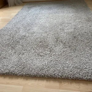 Large beige/cream medium pile rug